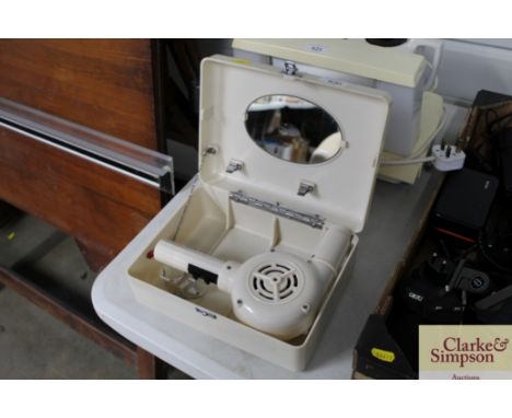 A travelling hairdryer in fitted case (sold as collectors item)