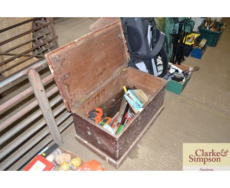 A wooden storage trunk with contents to include wood saws, screws etc.