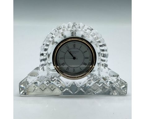 Lovely cut crystal case surrounding white face with black roman numeral clock. Waterford acid mark. Issued: 20th centuryDimen