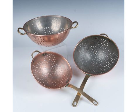 Rustic set of perforated copper bowls with bronze handles used for straining, rinsing, or draining liquids. Largest item meas