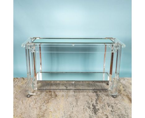 A sleek and radiant Mid-Century Modern rolling console table featuring two tiers of glossy Lucite surfaces. This striking pie
