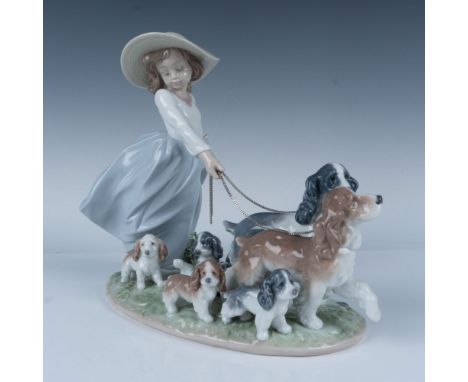 Glossy finish, modeled as a girl walking a family of dogs with their puppies. Lladro backstamp. Impressed 6784 to bottom base
