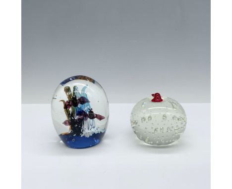 Gorgeous duo of paperweights that includes an orange and blue cave scene with adorable flying bats, and a clear apple with bu