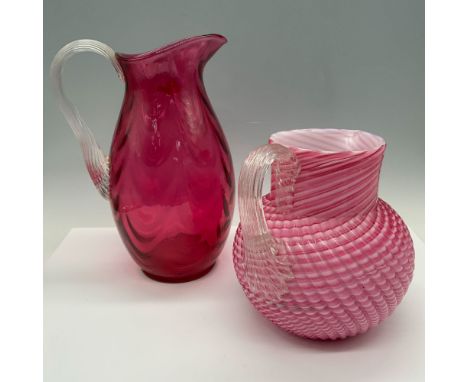 Handblown duo of glassware that consists of a Fenton pitcher of the Country Cranberry edition that combines hues of red to cr