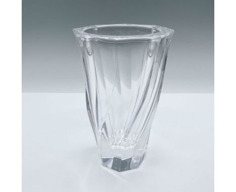 A clear flower vase with a swirl body. Orrefors marked on the underside. Issued: c. 1986 - 2014Dimensions: 3.75"L x 3.75"W x 