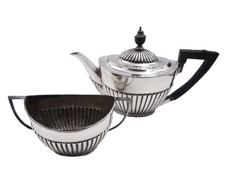 1920's silver teapot and twin handled sucrier, each of part fluted oval form, the teapot with ebonised handle and finial, hal