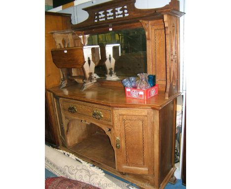 An Art Nouveau Oak mirrorback Sideboard with pierced, fret-cut detail mirror frame and shelf, single drawer, opposing cupboar