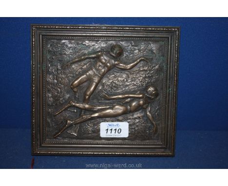 A bronzed Tile of deep sea divers.