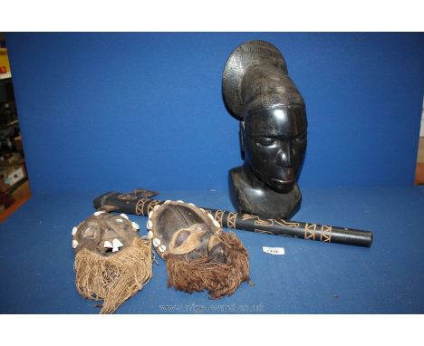 An African carved head, two portative West African tribal masks of the Dan People with cowrie shells and a decorative tribal 