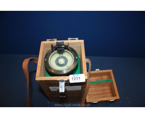 A hand held Ship's Compass in wooden case with leather handle by Saura.