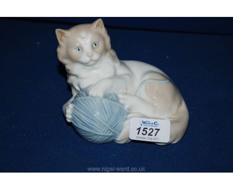 A Nao kitten with blue ball of wool