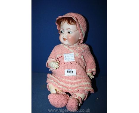 A Victorian bisque doll, impressed mark K & R 126 Simon Halbig, with mohair wig and crocheted clothes, eyes close and flirt f