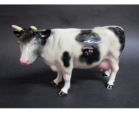 A early to mid 20th Century Melba Ware black and white ceramic cow 27cm long