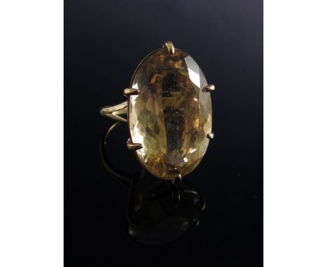 A 9ct gold ring set with large oval yellow citrine in six claw mount 