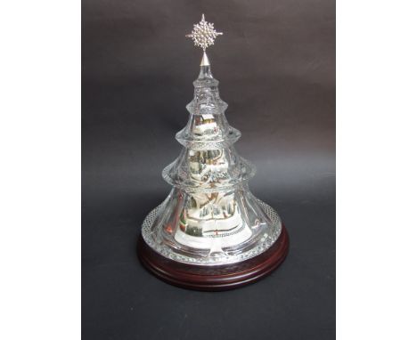 A Thomas Kinkade hand-painted village under a Christmas tree crystal dome, featuring lights and moving train circling the bas