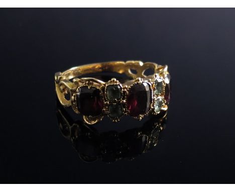 A 9ct gold ring set with garnets and emerald 