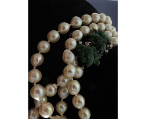 A double strand of cultured pearls with jade diamond set clasp, 80cm length 