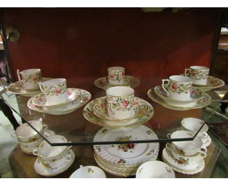 A set of six Derby, early 19th Century, coffee cans and saucers, hand painted with pink roses and trailing gilt, together wit
