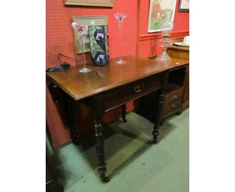 An Arts and Crafts walnut side table, the single frieze drawer over ring turned legs, on brass cup ceramic castors, 81cm long