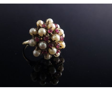 A pearl and garnet cocktail ring, stamped 14k