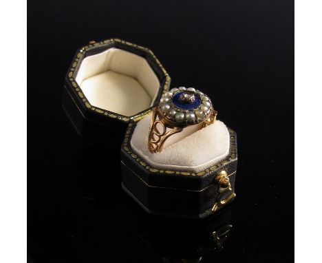 A Victorian ring the centre set with old cut diamond in blue enamelled and seed pearl frame, open scroll shoulders   