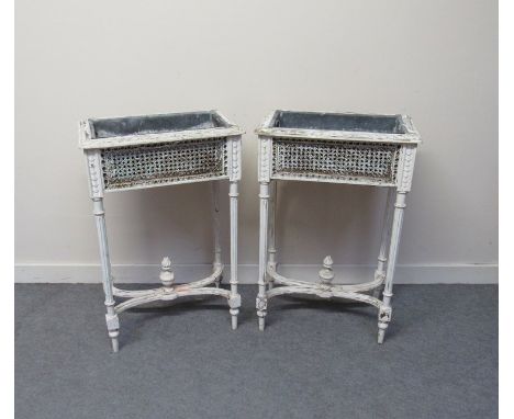 A pair of 19th Century painted planters with bergère sides over turned and reeded legs joined by an 'X' stretcher and central
