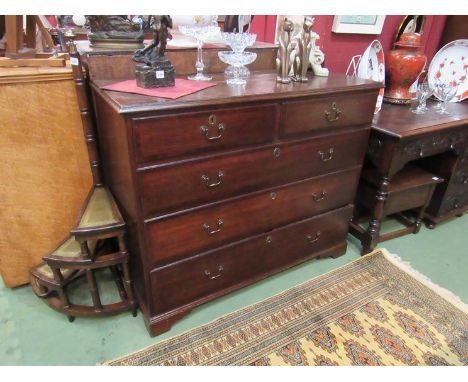 A George III oak chest of two short over three graduating long drawers over bracket feet with mahogany crossbanded decoration