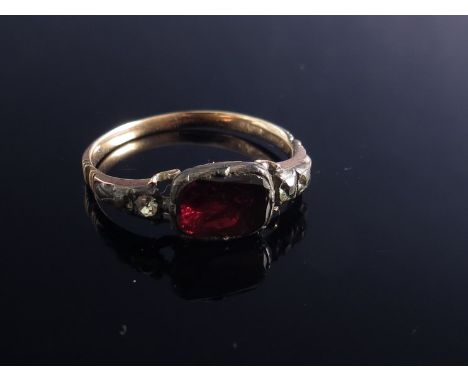A 19th Century garnet and white stone ring, closed back setting