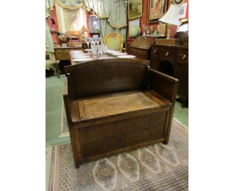 A 20th Century oak monk's bench with lift-up seat compartment, 91cm long