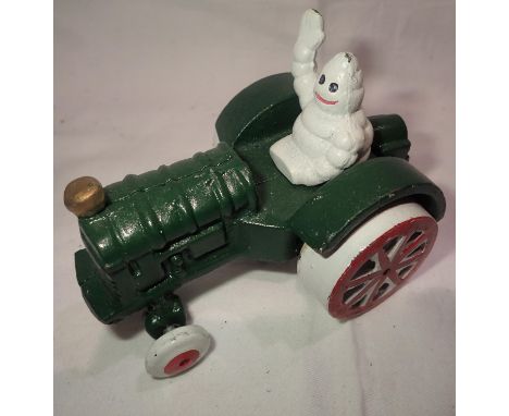 Cast iron Michelin man on a tractor, H: 8 cm. P&amp;P Group 1 (£14+VAT for the first lot and £1+VAT for subsequent lots) 