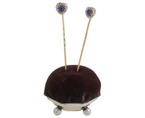 A pair of late 19th century sapphire and diamond-set stick pinseach centrally-set with a pear-shaped sapphire within a heart-