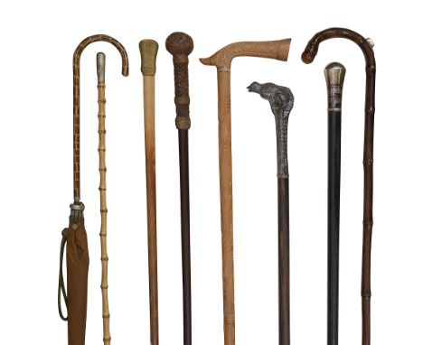 A collection of early 20th century walking canescomprising a bamboo racing cane with silver pencil, an Iraqi silver and niell