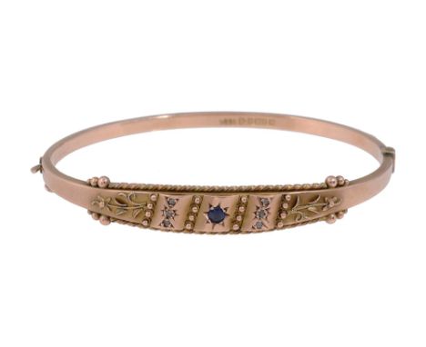 An Edwardian sapphire and 9ct gold hinge bangle of tapering and applied floral and bead design with twisted rope border, cent