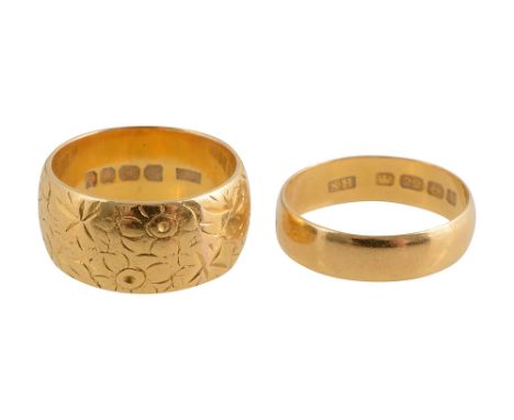 Two 22ct wedding bandsone chased with a floral design, stamped "22" with hallmarks, the other a plain band, stamped with Birm