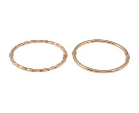 Two hinged bangles the first; plain hinged bangle, stamped "375" with securing clasp, the second; twisted hinged bangle, stam