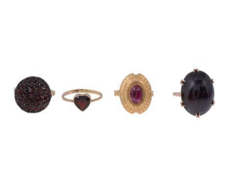 Four garnet ringsan oval garnet collet-set above the ornate oval and chased abstract design border, stamped "9ct"; an oval ca