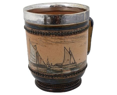 A Doulton Lambeth stoneware mug sgrafitto decorated with a continuous frieze of a seascape with yachts on a buff ground, an e