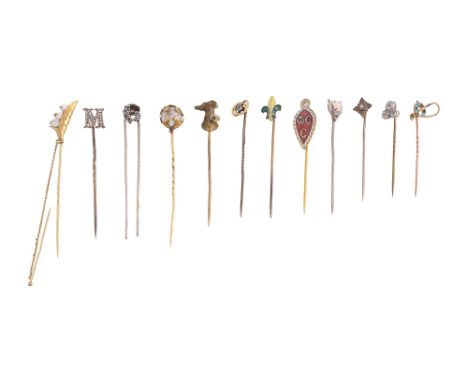 A collection of stick pinshorse and riding crop stick pin, stamped to reverse "9ct"; Lily of the valley stick pin with safety