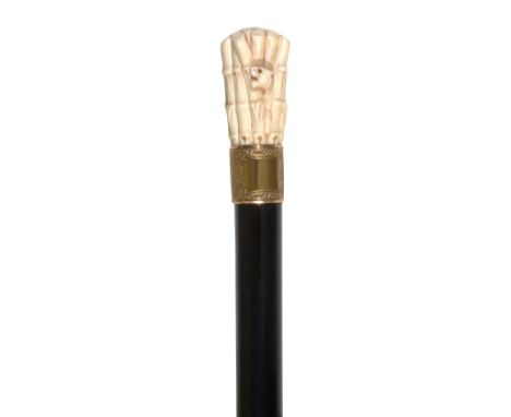 A late Victorian novelty walking canethe Japanese ivory pomel carved as tiger emerging from bamboo forest, gilt metal  collar