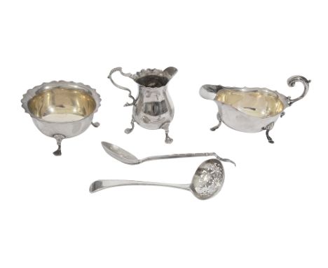 A collection of silver to include sauce boat, cream jug and other itemscomprising a sauce boat with wavy edged rim and scroll