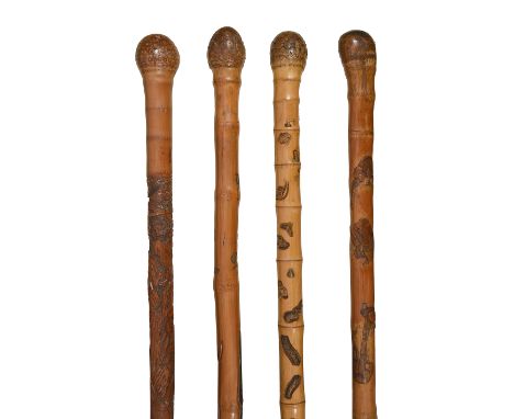 Four Japanese Meiji period bamboo walking sticks c.1900relief carved with root terminals, first carved with a snake, crabs, t