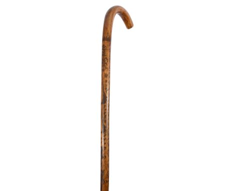 A late 19th century Folk Art scratch carved walking stick etched with with a hunting scene with mounted huntsmen following a 