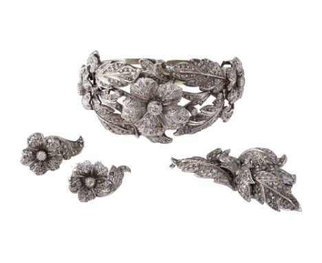 A Continental  diamond-set  composite suite comprising a hinged bangle (later fitting and clasp), a brooch  and a pair of ear