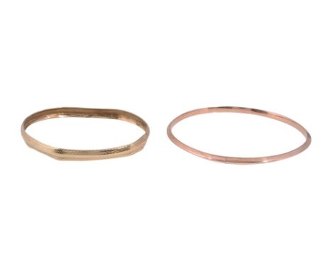 A 9ct gold bangle stamped with Birmingham hallmarks, together with a bangle with a chased abstract design (2) total approx we