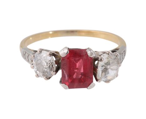 A spinel and diamond three stone ringthe central rectangular step-cut spinel set with an old brilliant-cut diamond to either 