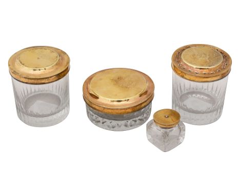 Three late 18th century French silver-gilt lidded cut glass toilet jars and and a inkwellunofficial control mark used by Asso