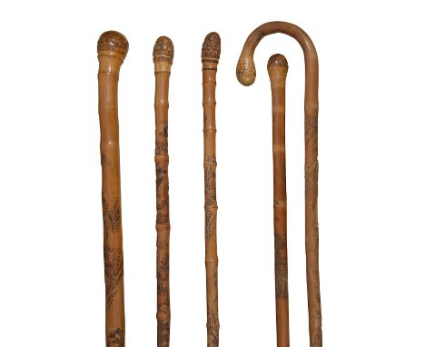 Five Japanese Meiji period bamboo walking sticks c.1900various carved with root terminals, one with a figure carrying a baske