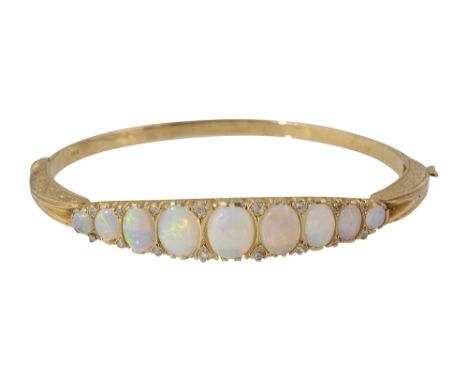 An 18ct yellow gold and  opal hinged banglethe top section set with a tapering line of graduated cabochon opals, diamond poin