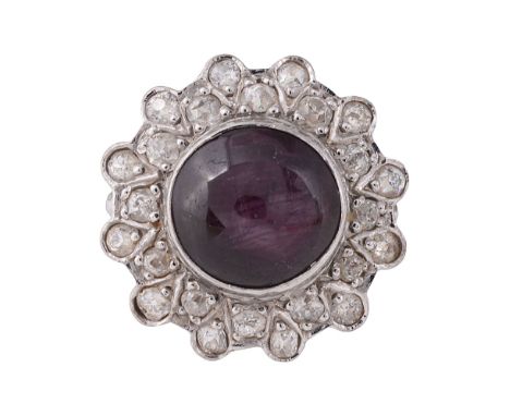 A synthetic ruby and diamond-set cluster ringthe circular cabochon ruby (untested but probably synthetic)  collet-set above d