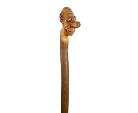 A grotesque novelty carved holly one piece walking stick &nbsp;c.1900the handle carved in the form of a grotesque man with a 